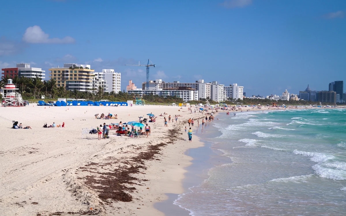 The beach at South Pointe Park looking north up the Miami Beach shoreline, with the red and white South Pointe lifeguard tower at the left