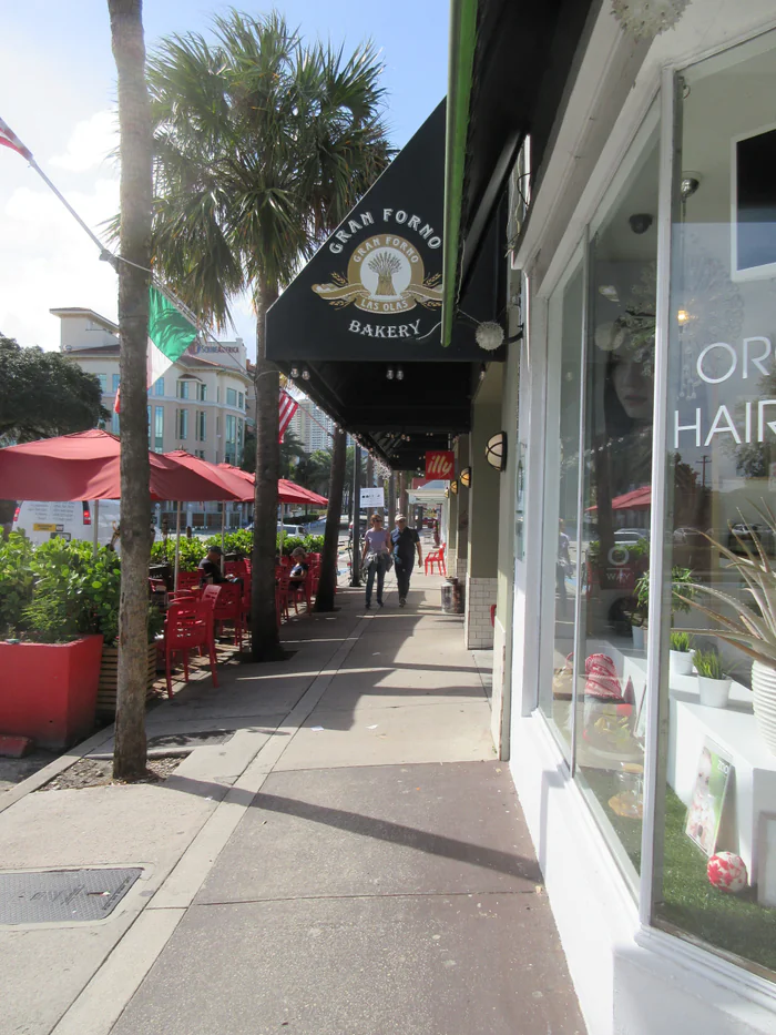 Shops and sidewalk tables on Las Olas Boulevard in Fort Lauderdale.