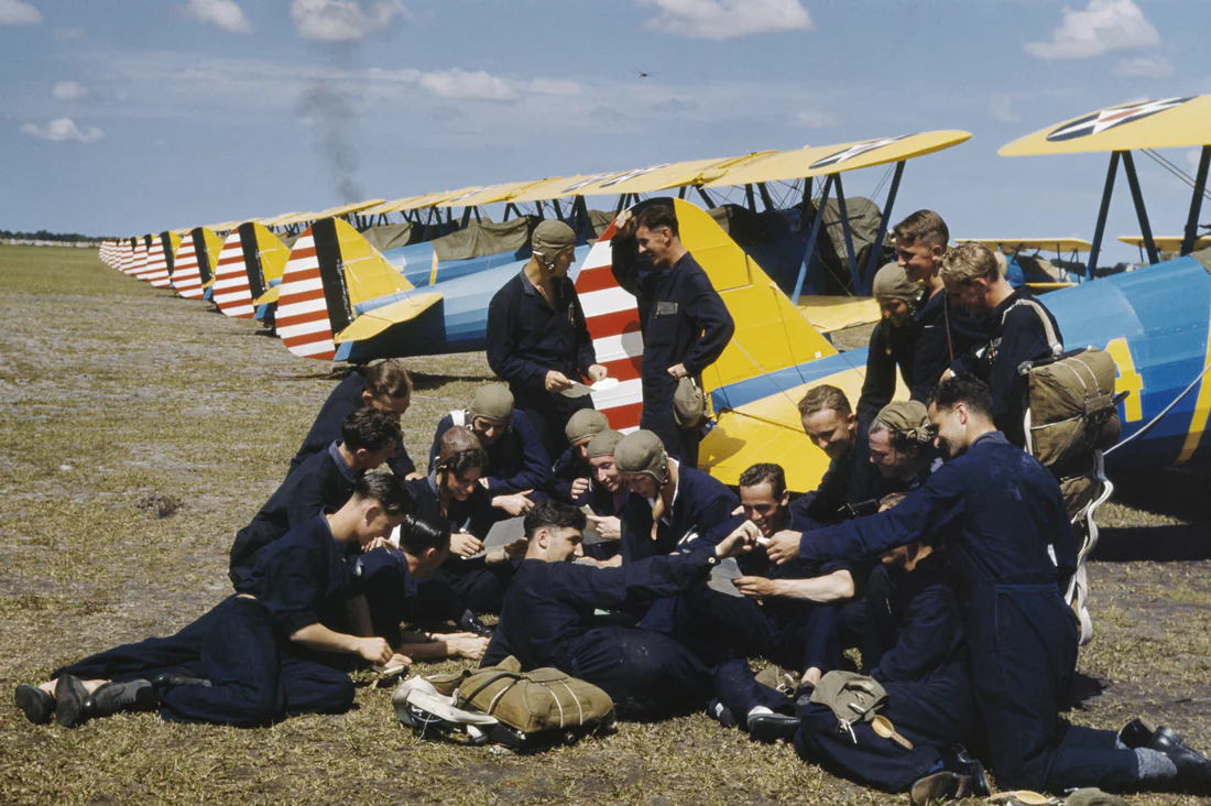 British airmen training at Carlstrom Field in Arcadia take a break beside their planes, summer 1941.