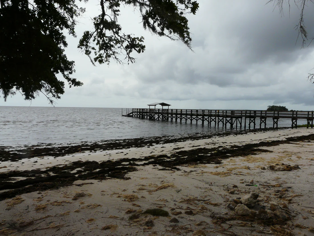 The sandy shore and fishing pier at Shired Island, 2021.