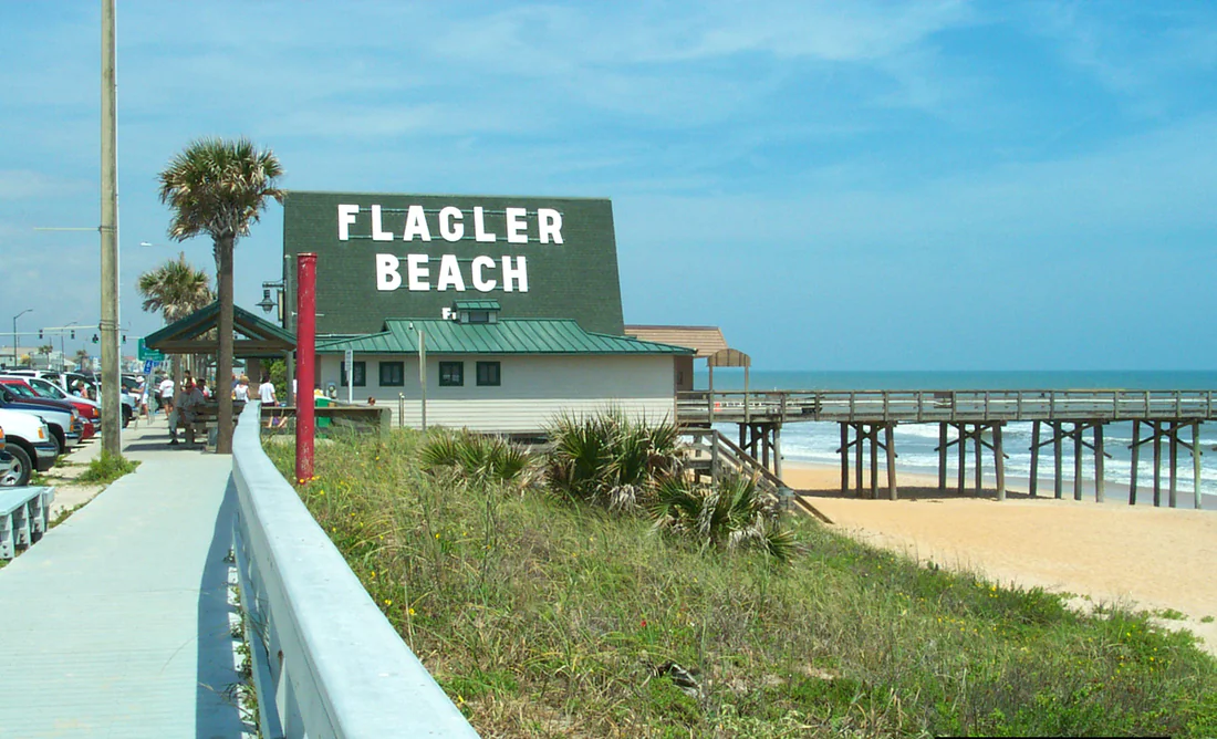 Big white letters spell Flagler Beach beside the walkway to the pier, 2004.