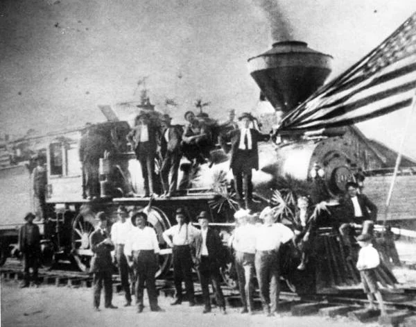 Men gathered on and around the first train into Apalachicola, about 1907.