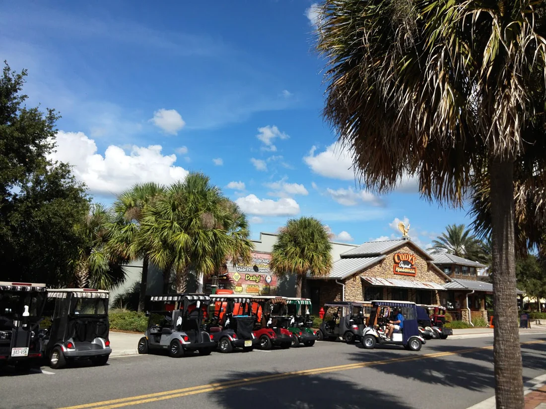 Golf cars parked at Lake Sumter Landing in The Villages, 2018.