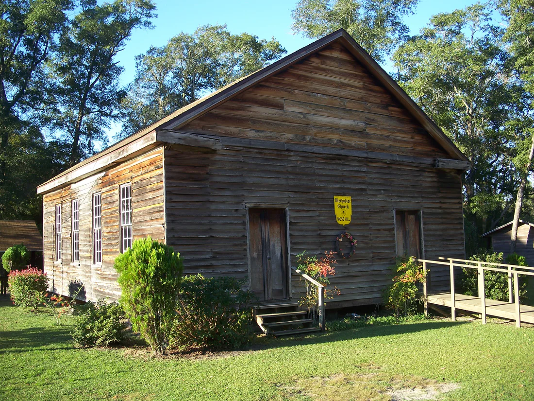 The plain, unpainted wood front of Moss Hill Church near Vernon, built in 1857.